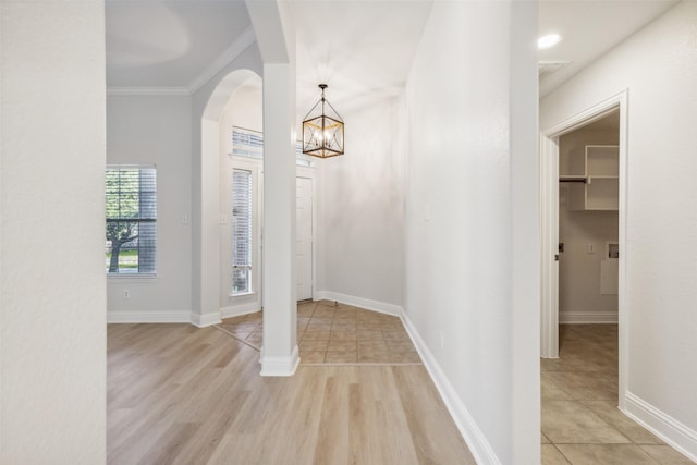 foyer with light wood-type flooring and ornamental molding