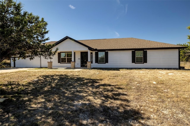 ranch-style house featuring an attached garage and a shingled roof