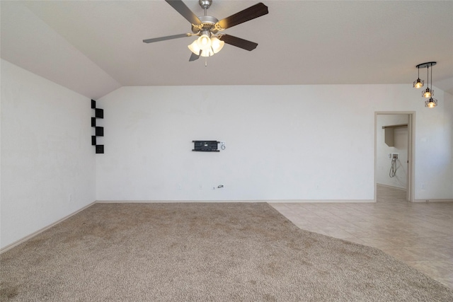 spare room with baseboards, light colored carpet, lofted ceiling, ceiling fan, and light tile patterned floors