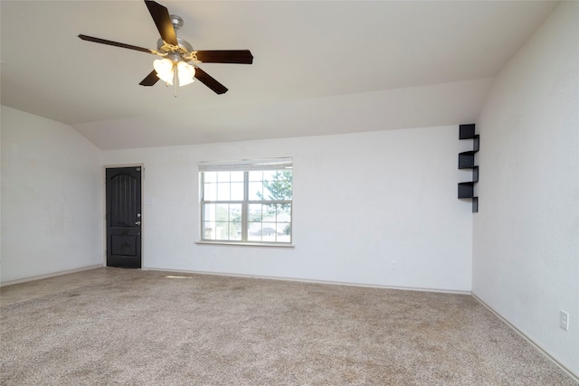 spare room with lofted ceiling, carpet, and ceiling fan