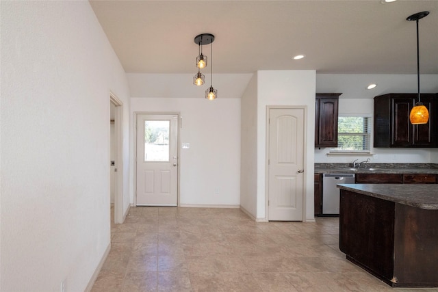 kitchen featuring dark countertops, dishwasher, dark brown cabinets, baseboards, and hanging light fixtures