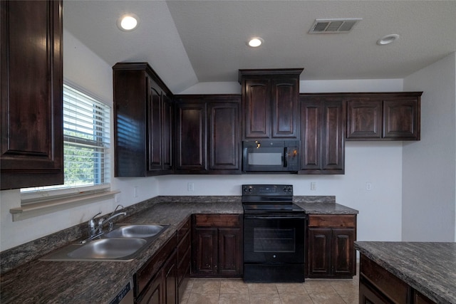 kitchen featuring dark countertops, dark brown cabinets, a sink, black appliances, and visible vents
