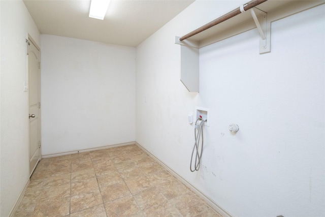 washroom featuring stone finish flooring, baseboards, laundry area, and washer hookup