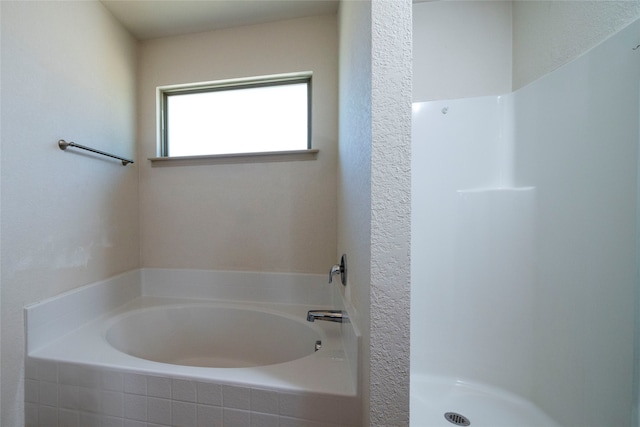 bathroom featuring separate shower and tub