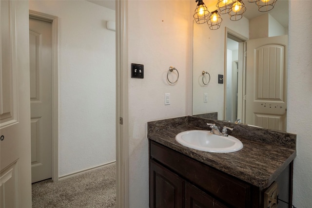 bathroom featuring vanity and a chandelier