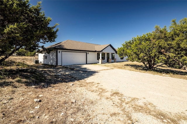 view of front of home with cooling unit and a garage