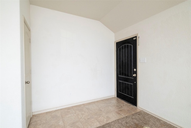 unfurnished room with lofted ceiling and baseboards
