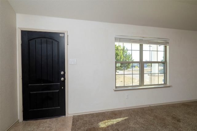 view of carpeted foyer