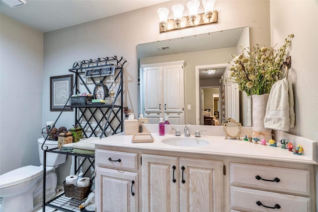 bathroom featuring vanity and toilet