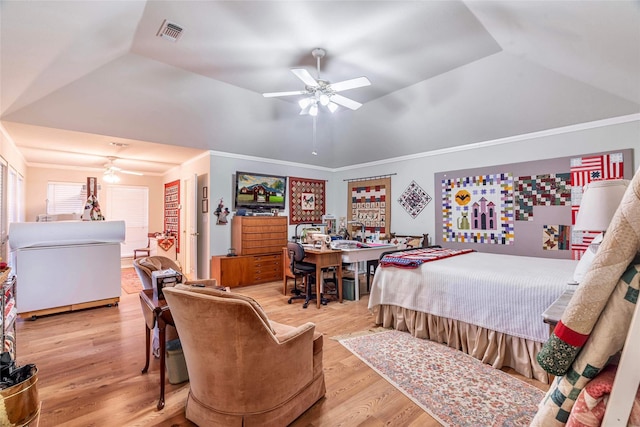 bedroom with light hardwood / wood-style floors, vaulted ceiling, ceiling fan, and ornamental molding