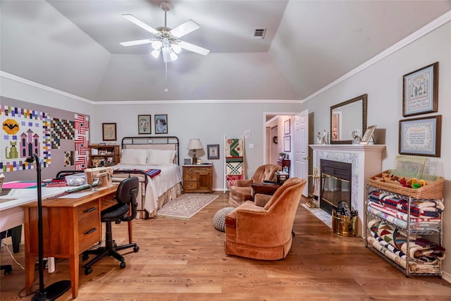 bedroom with ceiling fan, lofted ceiling, crown molding, and light hardwood / wood-style flooring