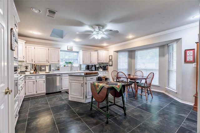 kitchen with white cabinetry, dishwasher, ceiling fan, and ornamental molding