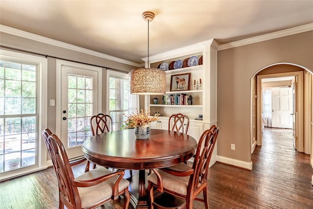 dining area with crown molding and dark hardwood / wood-style floors