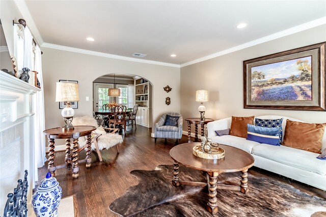 living room with dark wood-type flooring and ornamental molding