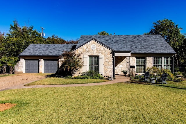 view of front of home with a front lawn and a garage