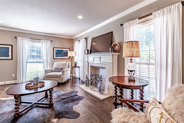 living room featuring a wealth of natural light, ornamental molding, dark hardwood / wood-style floors, and a tile fireplace