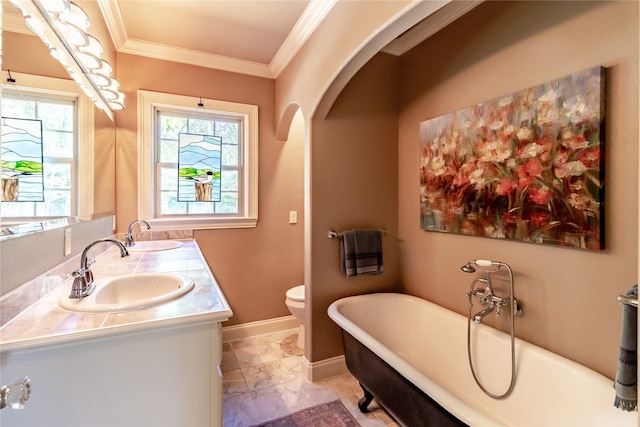 bathroom featuring a bath, toilet, crown molding, and vanity