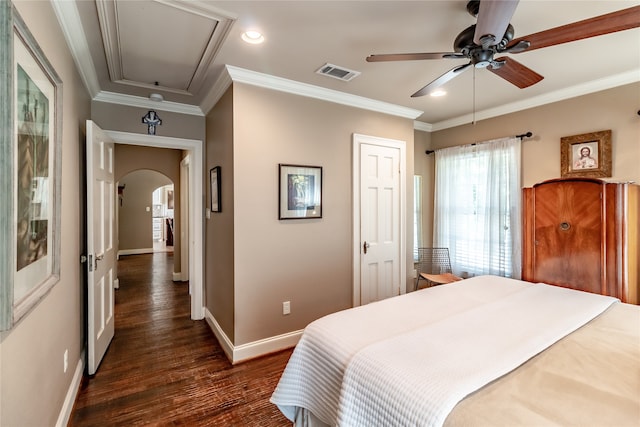 bedroom with ornamental molding, dark wood-type flooring, and ceiling fan