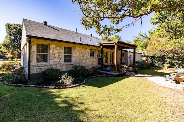 rear view of property with a yard and a patio