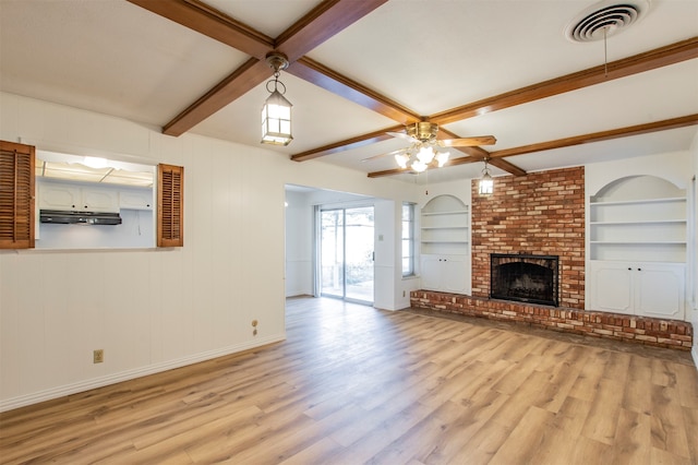 unfurnished living room with light hardwood / wood-style floors, beam ceiling, ceiling fan, and a brick fireplace