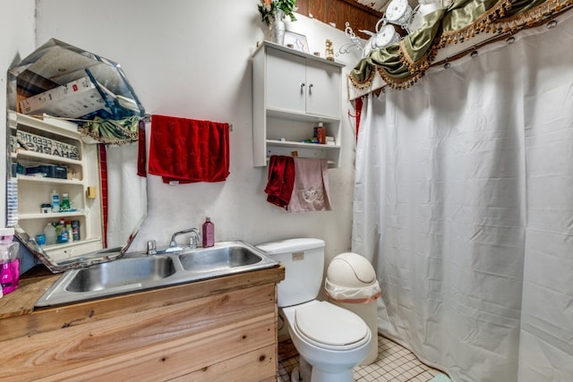 bathroom with vanity, a shower with curtain, toilet, and tile patterned floors