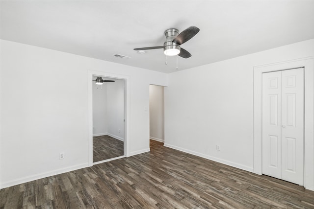 unfurnished bedroom with a closet, ceiling fan, and dark hardwood / wood-style floors