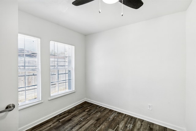 empty room with ceiling fan, a healthy amount of sunlight, and dark hardwood / wood-style flooring