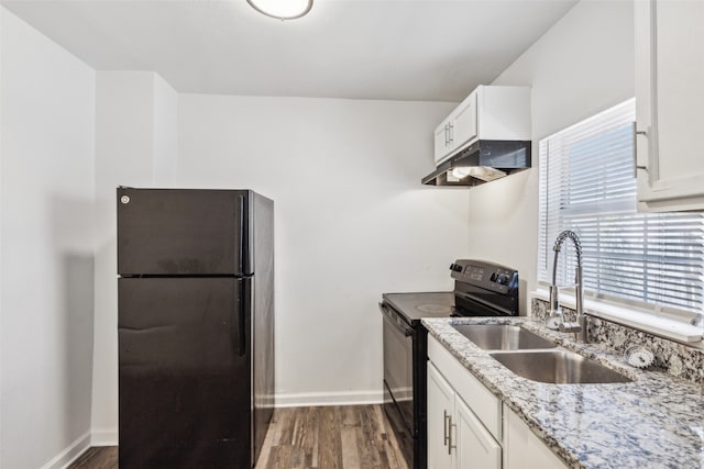 kitchen with white cabinets, light stone countertops, black appliances, dark wood-type flooring, and sink