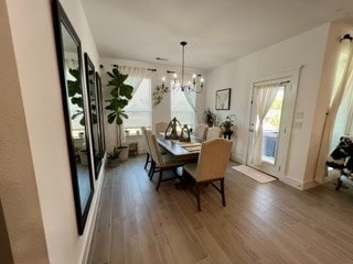 dining space with a chandelier and dark hardwood / wood-style floors