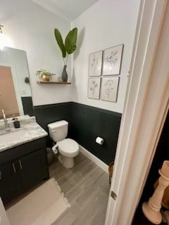 bathroom featuring hardwood / wood-style floors, vanity, and toilet