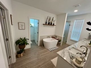 bathroom featuring separate shower and tub, vanity, and hardwood / wood-style flooring