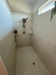 bathroom with tiled shower