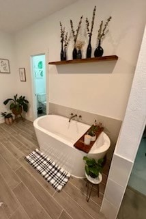 bathroom with a tub to relax in