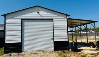 view of outdoor structure featuring a carport and a garage