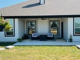 back of property featuring a lawn, an outdoor living space, and ceiling fan