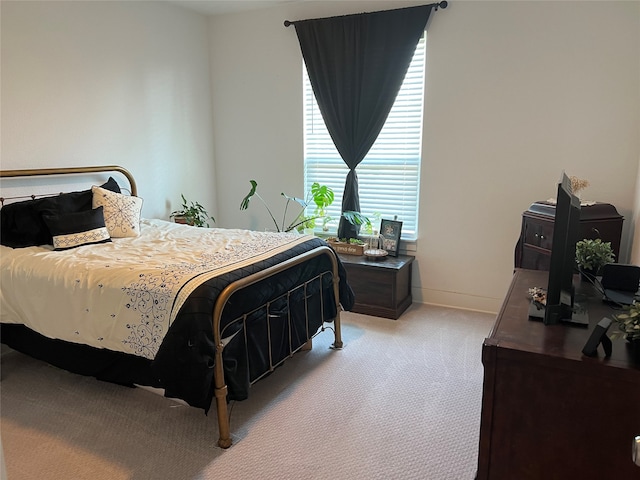 bedroom featuring light colored carpet