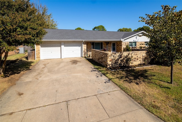 ranch-style house with a garage and a front lawn