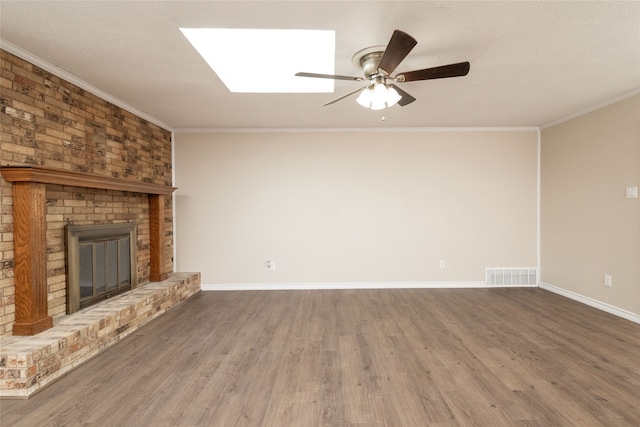 unfurnished living room featuring ornamental molding, dark wood-type flooring, and a fireplace