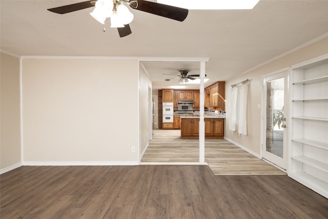 unfurnished living room with ornamental molding, light hardwood / wood-style floors, and ceiling fan