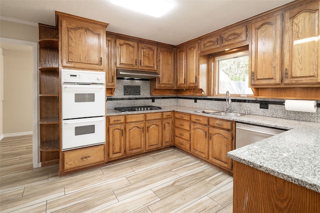 kitchen featuring decorative backsplash, stainless steel appliances, ornamental molding, sink, and light stone countertops