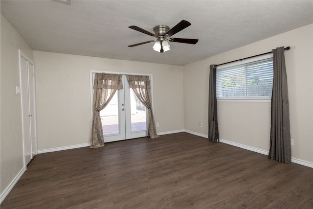 empty room featuring dark wood-type flooring, ceiling fan, french doors, and plenty of natural light