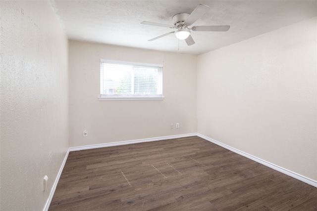 unfurnished room with ceiling fan and dark hardwood / wood-style floors