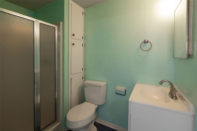 bathroom with vanity, toilet, and an enclosed shower