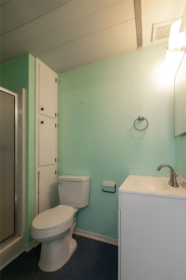 bathroom with vanity, a shower with shower door, and toilet