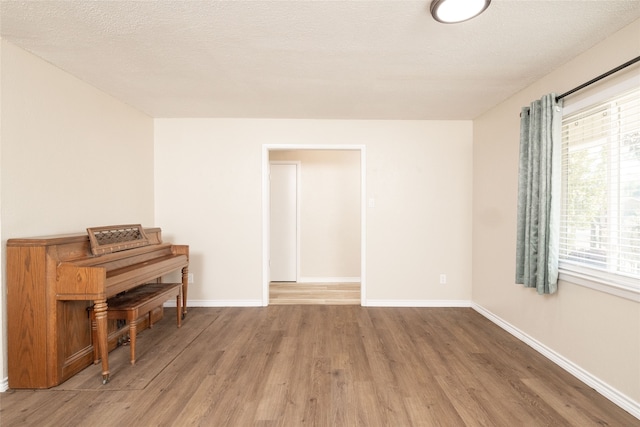 miscellaneous room featuring hardwood / wood-style floors and a textured ceiling