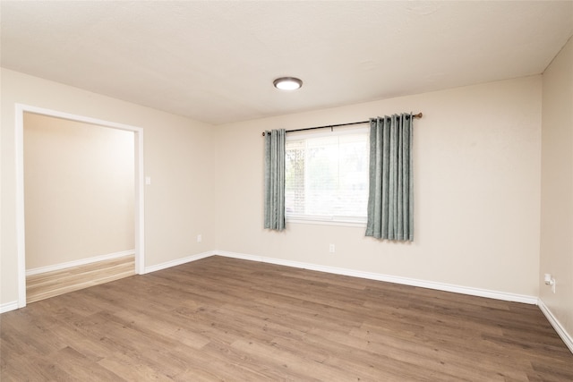 empty room with wood-type flooring