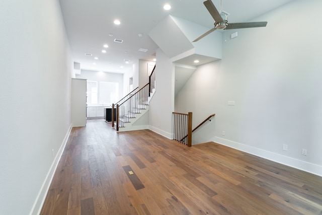 unfurnished living room featuring ceiling fan and hardwood / wood-style flooring