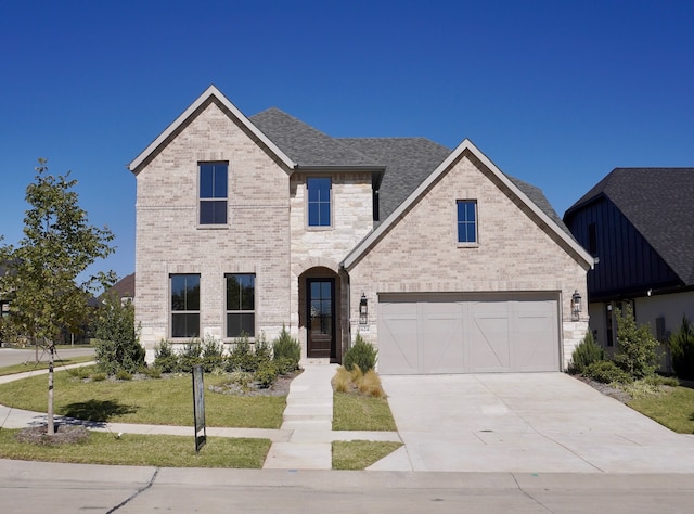 view of front of house with a front yard and a garage