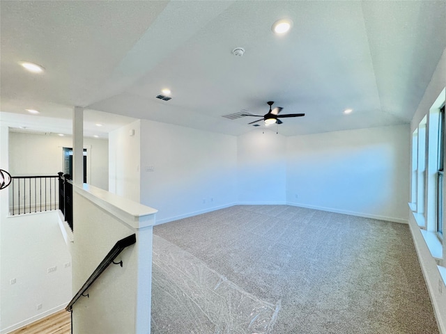 carpeted empty room featuring ceiling fan