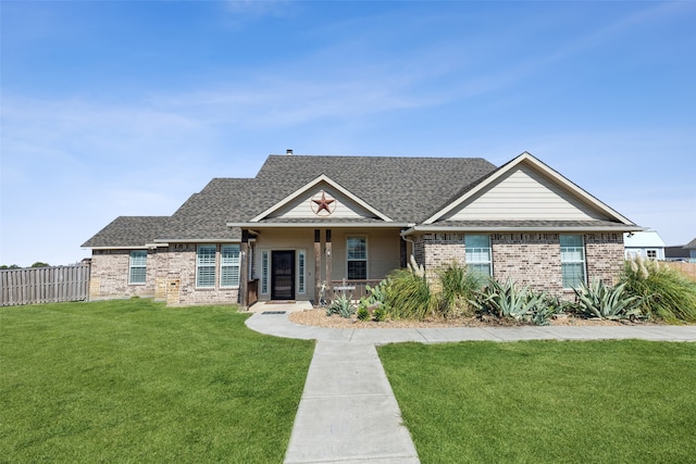 view of front of home with covered porch and a front lawn